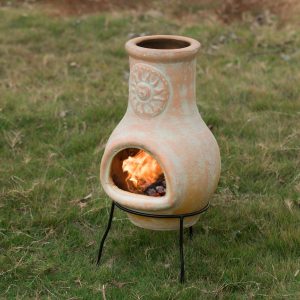 A new type of outdoor clay designed fireplace with a metal bracket and charcoal burning pit